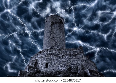Ominous night sky with thunderstorms and lightning behind the dark facade of an old knight's castle