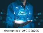 Omni Channel Marketing Concept. Businessman holding digital representation of omni-channel marketing, e-commerce, delivery, social media, analytics, customer engagement, and customer service icons.