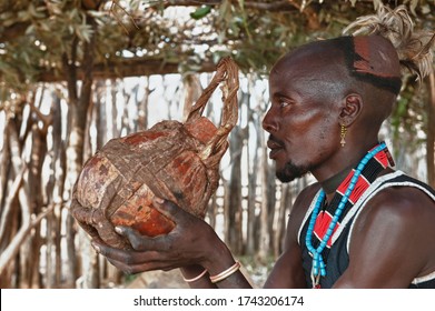 Omo River Valley – October 15, 2010:  Hamar man drinking sorghum beer from a calabash, Omo river valley, Southern Ethiopia