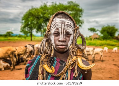 OMO VALLEY, ETHIOPIA - MAY 7, 2015 : Young boy from the African tribe Mursi with traditional horns in Mago National Park, Ethiopia.