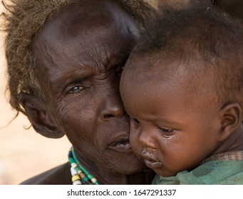 Omo/Ethiopia-January 12 2020 Year:Portrait of an Ethiopian woman from the Desanech tribe with a child in her arms