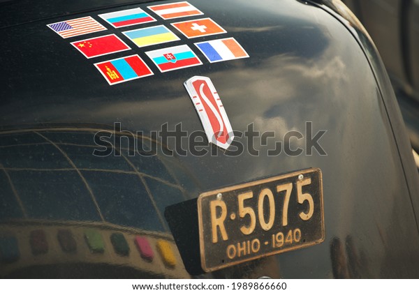 Omsk city, Russia - june 11, 2013: Stage of\
Peking to Paris Motor Challenge - 1940 Studebaker President closeup\
rear end details view. Vintage license plate and national flags\
stickers