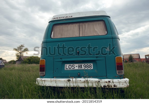 Omsk\
region, Russia - june13, 2021: bus for travel Volkswagen T2\
Westfalia on the grass field. Close up rear\
view