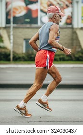 Omsk, Russia -  September 20, 2015: Old Man Runner Running On Street During Siberian International Marathon