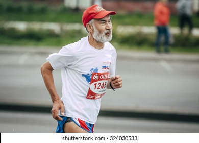 Omsk, Russia -  September 20, 2015: Old Man Runner Running On Street City During Siberian International Marathon