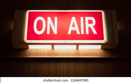 On Air Sign Icon Glowing On The Wooden Wall Of Sound Recording Studios, Live Broadcast Radio Production Room