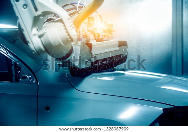 On the automobile manufacturing line, the\
robotic arm is grinding the car\
frame