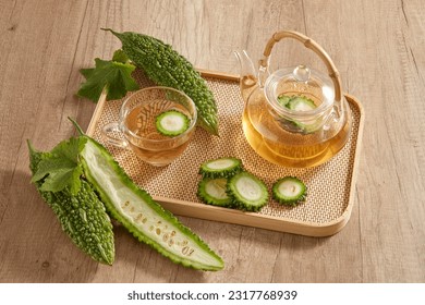 On the bamboo tray featured a transparent tea set with bitter melon. Bitter melon (Momordica charantia) tea has a lot of vitamin C and anti-aging substances