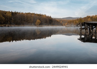 On the bank of misty, morning lake. Beautiful panoramic view from Rudawa, Poland. Spring sunrise in Orlicke mountains.  - Powered by Shutterstock