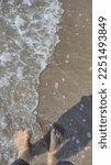 On the beach with small waves dragging the sand