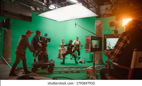 On Big Film Studio Professional Crew Shooting Period Costume Drama Movie. On Set: Directing Green Screen Scene with Gentleman Protecting Lady from Actor Playing Monster Wearing Motion Capture Suit - Shutterstock ID 1793697910