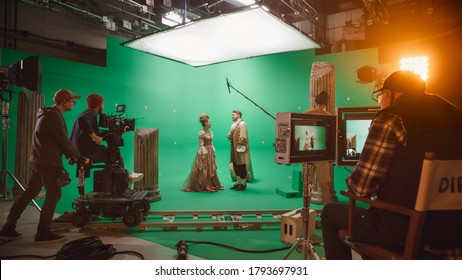 On Big Film Studio Professional Crew Shooting Period Costume Drama Movie. On Set: Director Controls Cameraman Shooting Green Screen Scene with Two Actors Talented Wearing Renaissance Clothes Talking