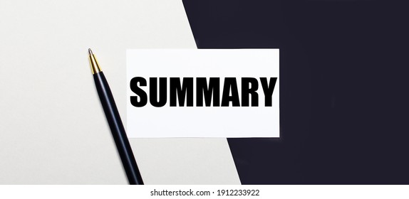 On a black and white background lies a pen and a white card with the text SUMMARY.
