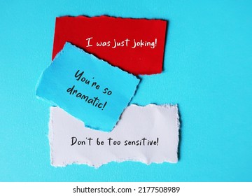 On blue background, torn paper with handwriting I WAS JUST JOKING, YOU'RE SO DRAMATIC and DON'T BE SO SENSITIVE, gaslighting verbal abuse use to manipulate and pin whole blame to victim - Shutterstock ID 2177508989