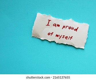 On Blue Copy Space Background, Torn Paper With Handwriting I AM PROUD OF MYSELF, Concept Of Using Positive Sentence Mantra Affirmation To Immediately Change The Way We Think And Can Boost Self Esteem