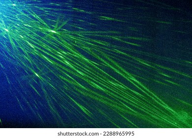 On a blue gradient background, a pattern of green narrow rays