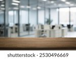 On the blurred background of the empty office room, a wooden board rested atop the table