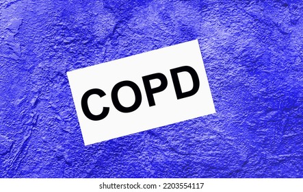 On A Bright Blue Abstract Background, There Is A White Card With The Text COPD Chronic Obstructive Pulmonary Disease