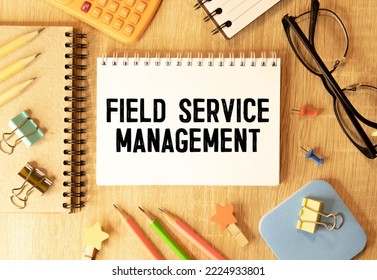 On A Bright Blue Background, Light Wooden Blocks And Cubes With The Text FSM Field Service Management.