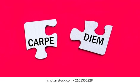 On a bright red background, two white puzzles with the text CARPE DIEM. View from above.
