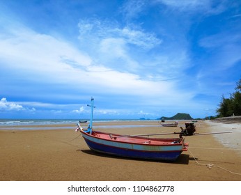 On Bright Sunny Day With Beautiful Sky, Local Fishing Boats Aground And Waiting For The Rising Tide At Pran Buri, Thailand