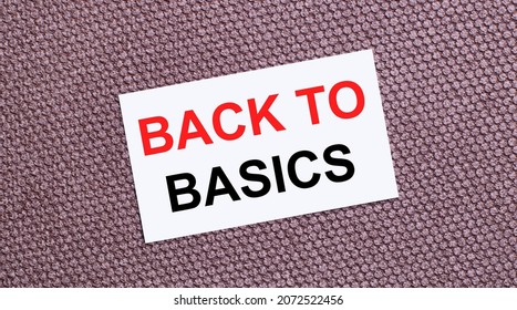 On a brown background, a white rectangular card with the text BACK TO BASICS