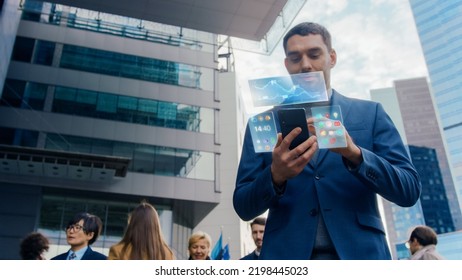 On Busy City Street Handsome Businessman Uses Smartphone with Edited Visual Holographic Screens Show Business Graphs, Charts and Stock Market Analysis Statistics. Mock-up Mobile OS UI, UX. - Powered by Shutterstock