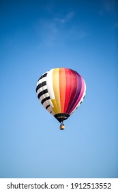 On a clear sunny day in spring, this beautiful flying hot air balloon is taking off