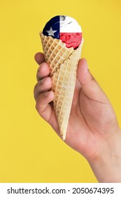 On A Colorful Background, A Hand With Ice Cream In The Form Of The Flag Of State Of Texas