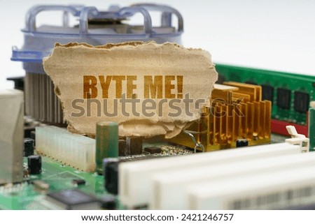 On the computer motherboard there is a cardboard with the inscription - Byte me. Computer concept.