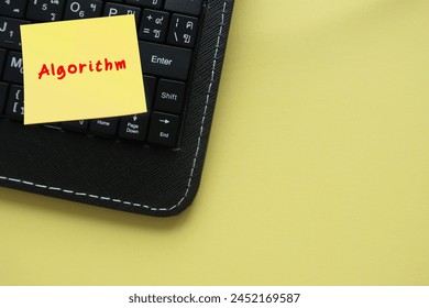 On copyspace yellow background, note on keyboard written Algorithm - finite sequence of rigorous instructions, typically used to solve a class of specific problems or to perform computation