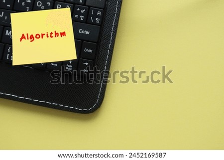 On copyspace yellow background, note on keyboard written Algorithm - finite sequence of rigorous instructions, typically used to solve a class of specific problems or to perform computation