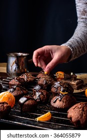 
on a dark background cooking homemade chocolate cakes . 
The hand holding a cupcake - Shutterstock ID 364055879