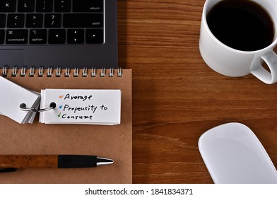 On The Desk There Is A Laptop, A Cup Of Coffee, And A Word Book With The Word Financial Term Asset Backed Security.