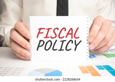 On The Desktop There Are Documents, Pen, Black Paper Clips And A Notebook With The Text FISCAL POLICY. Business Concept