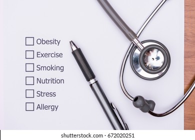 On the doctor's desk, Doctor assess the patient's history and what are the risks to cause a disease with his Diagnose Form. - Powered by Shutterstock