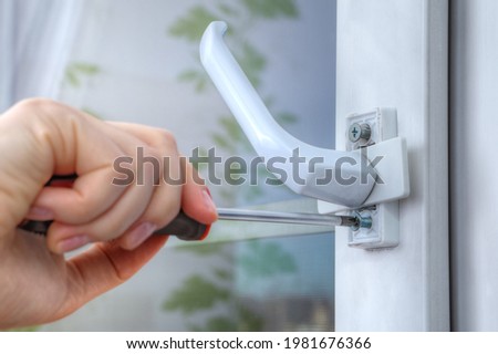 On double hung window, dismantle handle to supply restrictor that adjusts width of opening.