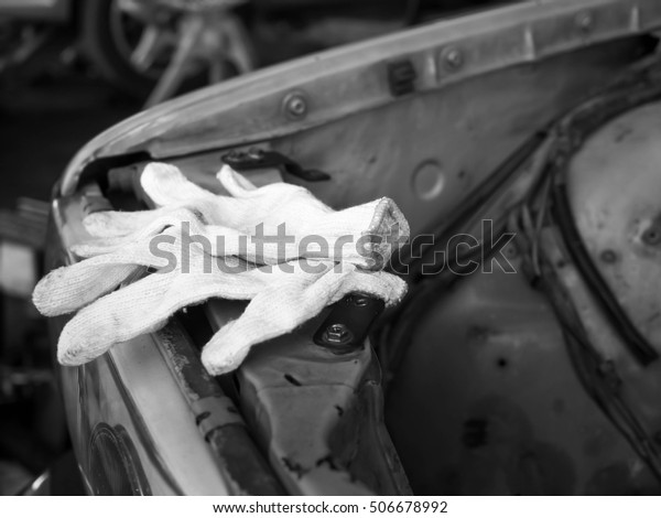 on duty dirty glove with car engine with tools\
made with vintage filter