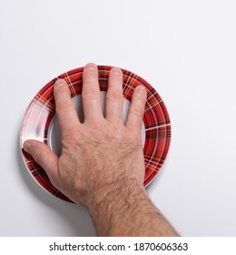 On An Empty Plate The Hand Of A Man Vowing To Keep His Promise To Starve