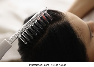 On Female Hair There Is Device For Restoration Of Hair Follicles. Combating Hair Loss Concept