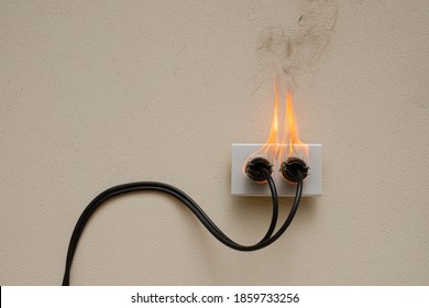 On fire electric wire plug Receptacle on the concrete wall exposed concrete background with copy space