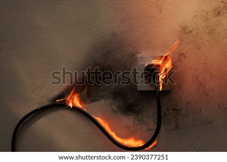 On fire electric wire plug Receptacle on the concrete wall exposed concrete background with copy space