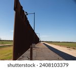 On Going Crisis at US Southern Border:  Border Wall between Texas and Mexico along the Rio Grande River; view includes service road