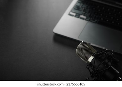 On A Gray Background, An Open Laptop And A Studio Microphone. Radio, Blogging, Journalism, Presentation, Home Office. There Are No People In The Photo. Low Angle View.