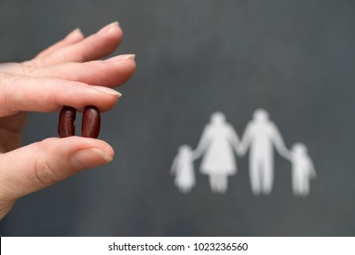 On A Gray Background Silhouette Of A Family, Hands Holding Beans, Concept Of Awareness Of Kidney Disease