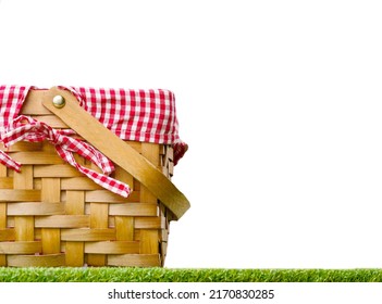 On The Green Bright Grass Is A Beautiful Picnic Basket. Isolated On A White Background. Family Outdoor Recreation, Romance, Picnic. There Are No People In The Photo. There Is Free Space To Insert.