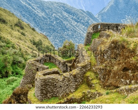 On the Inca Trail in Peru, old ruins of an Inkan stone building, shaped to blend with the natural surroundings in the Andes mountains.