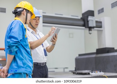 On July 6, 2016, workers and engineers of Daming Stainless Steel Co., Ltd. in Wuxi, Jiangsu, China, exchanged the working status of metal detection instruments. - Shutterstock ID 1093306319