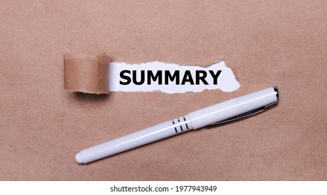 On kraft paper, a white pen and a white strip of paper with the text SUMMARY.