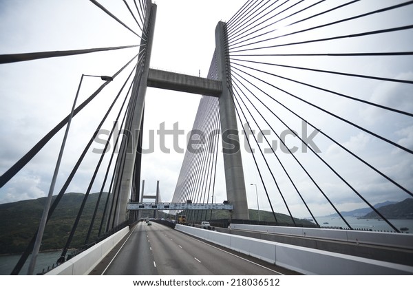On the left side of the\
highway driving route at Bottom looking up of modern cable-stayed\
bridge 